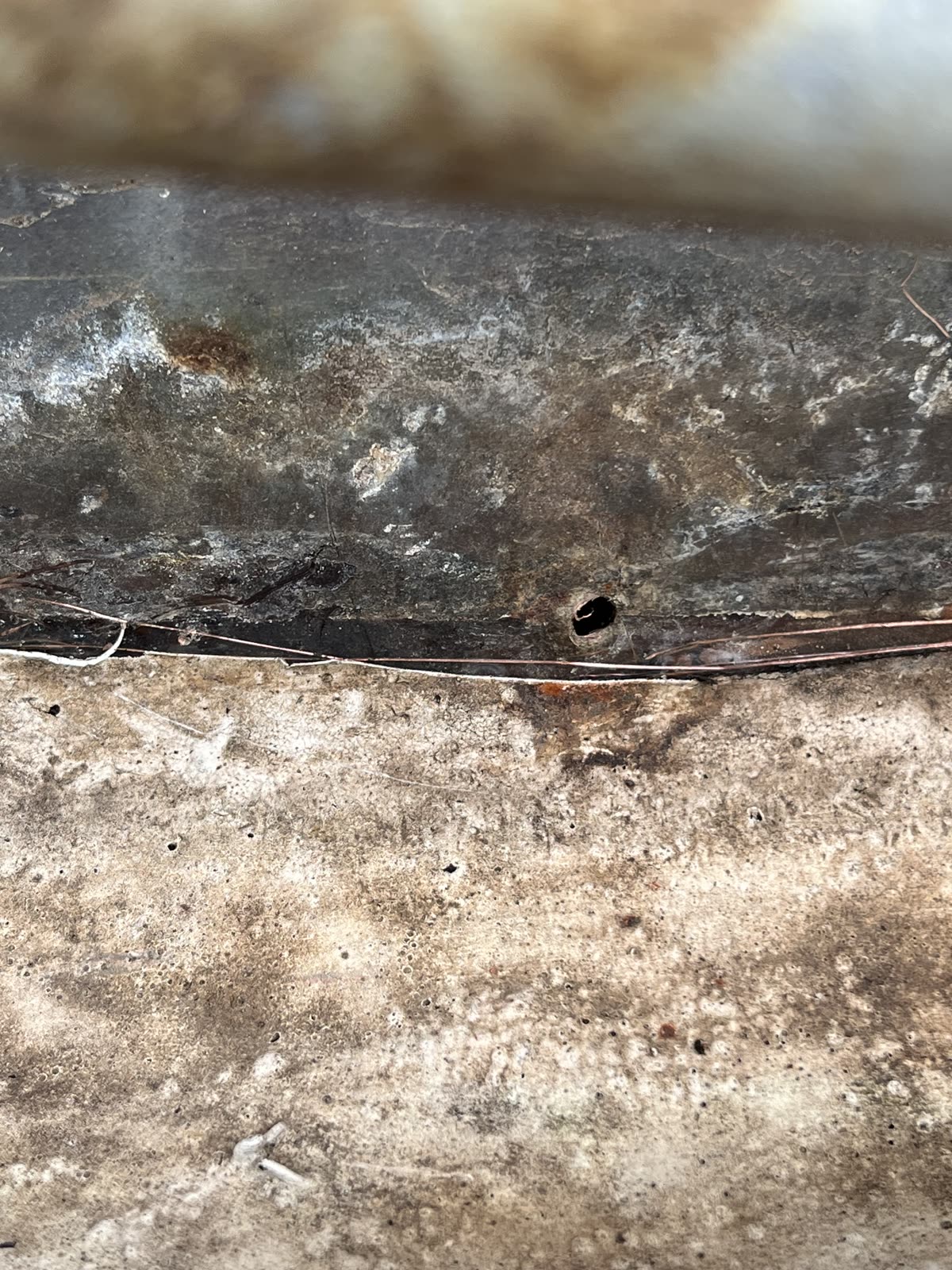 Hole in flat roof flashing before silicone coating repair, Winnetka IL