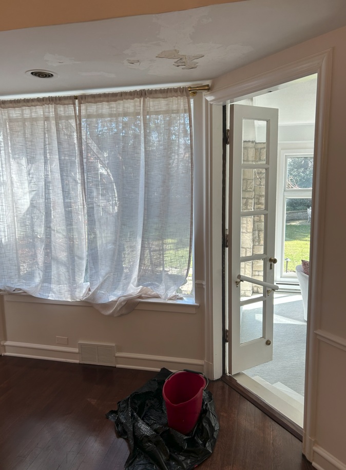 Interior room with leaking ceiling, bucket on floor, Winnetka IL