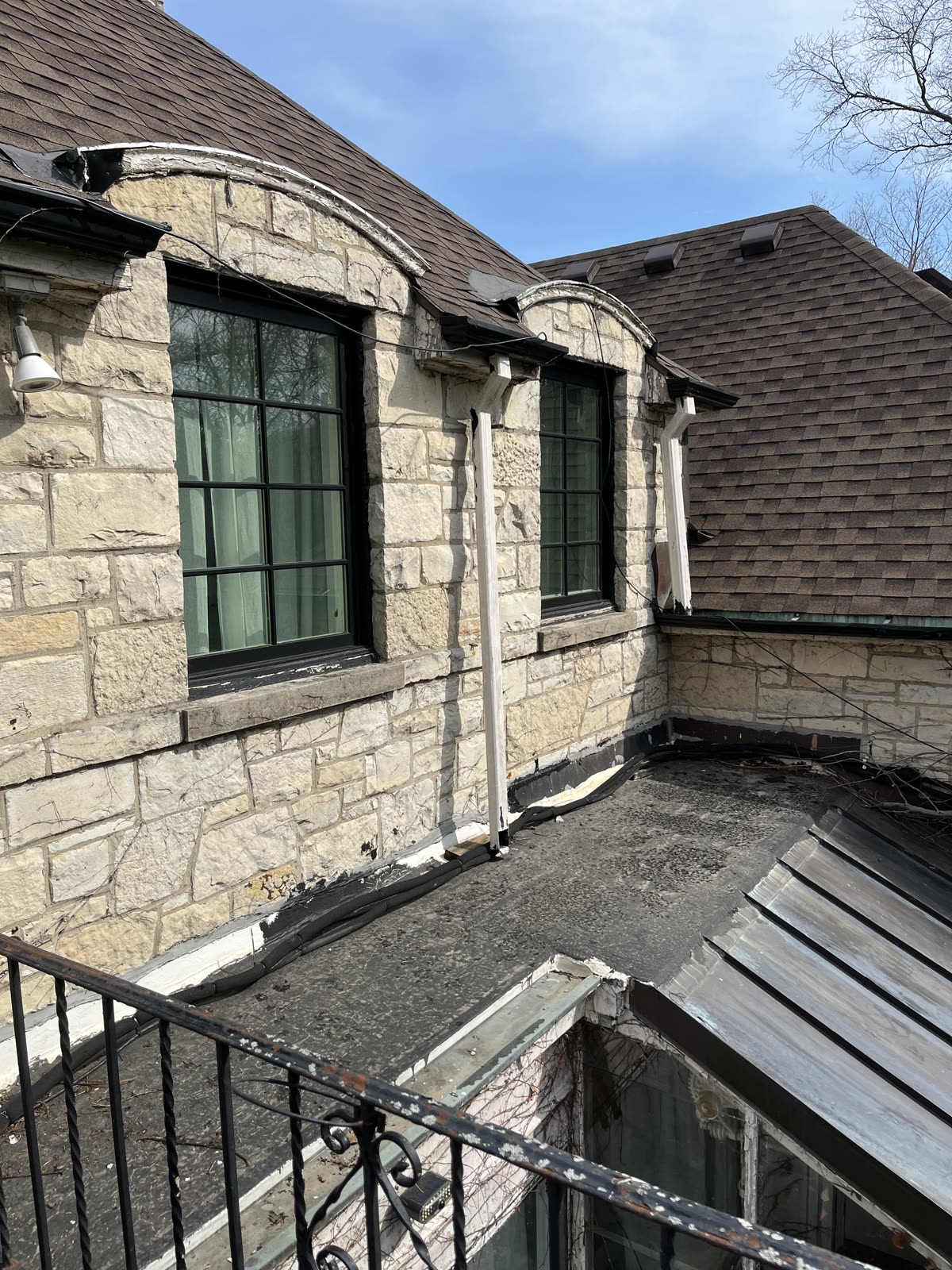 Narrow roof section on Winnetka stone home before silicone coating repair