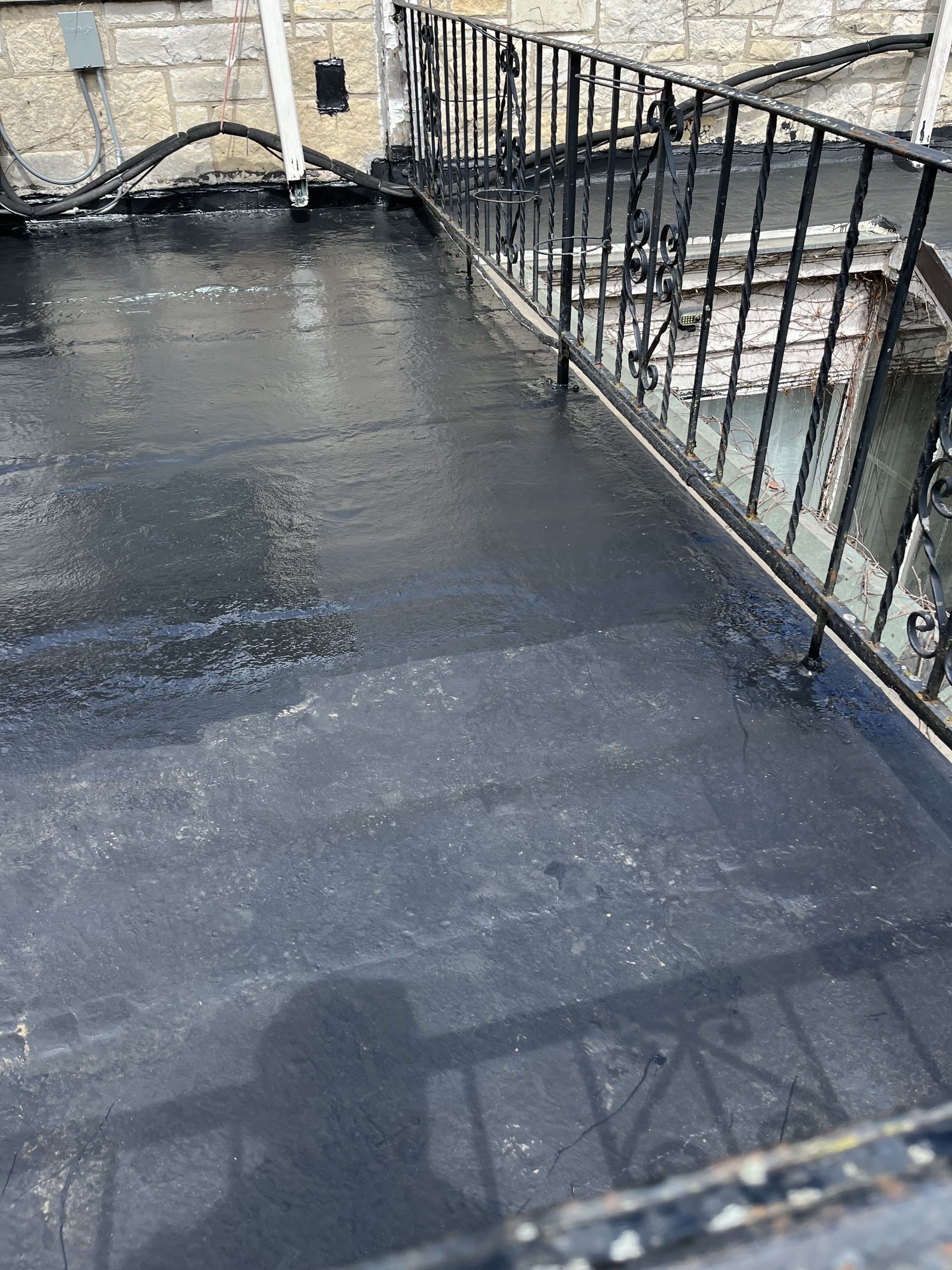 Close view of freshly applied Gaco silicone coating on balcony roof, Winnetka IL